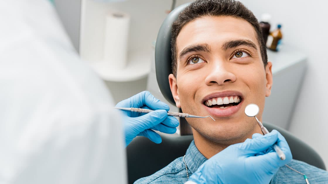 Man in dentist chair having exam